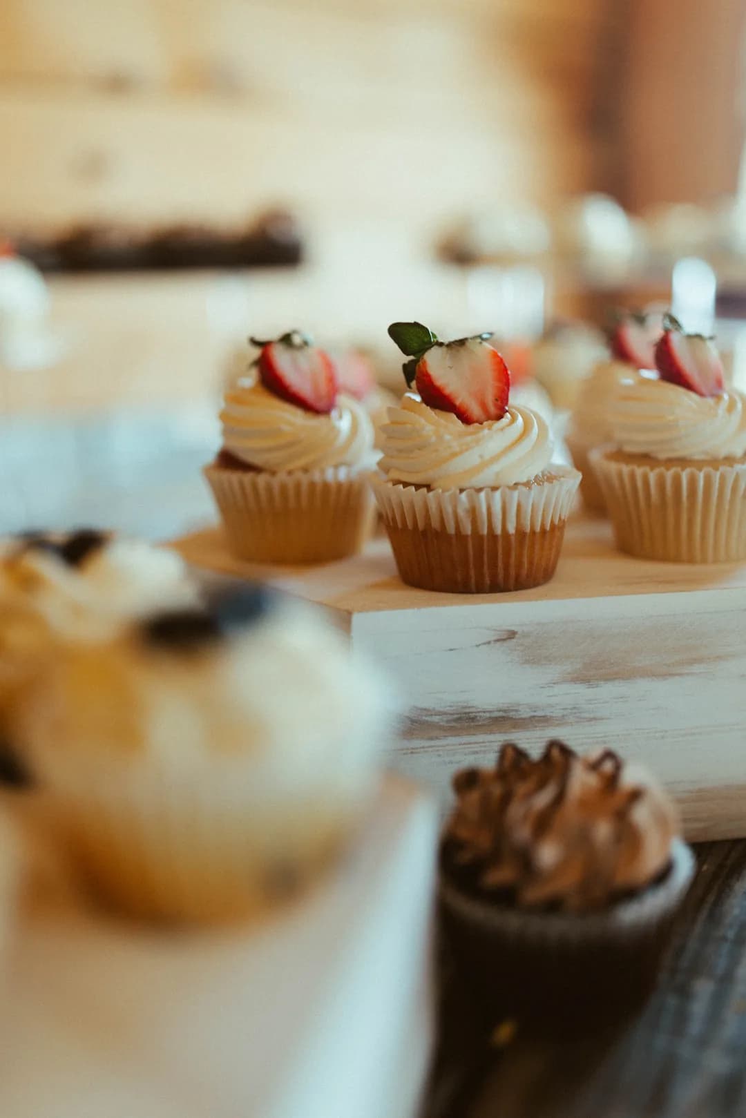 Strawberry-topped cupcakes on a tiered stand
