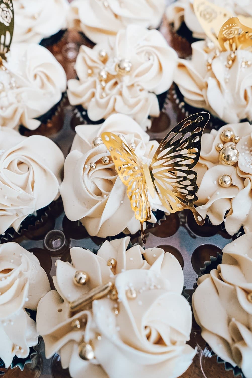 White rosette cupcakes with gold butterflies