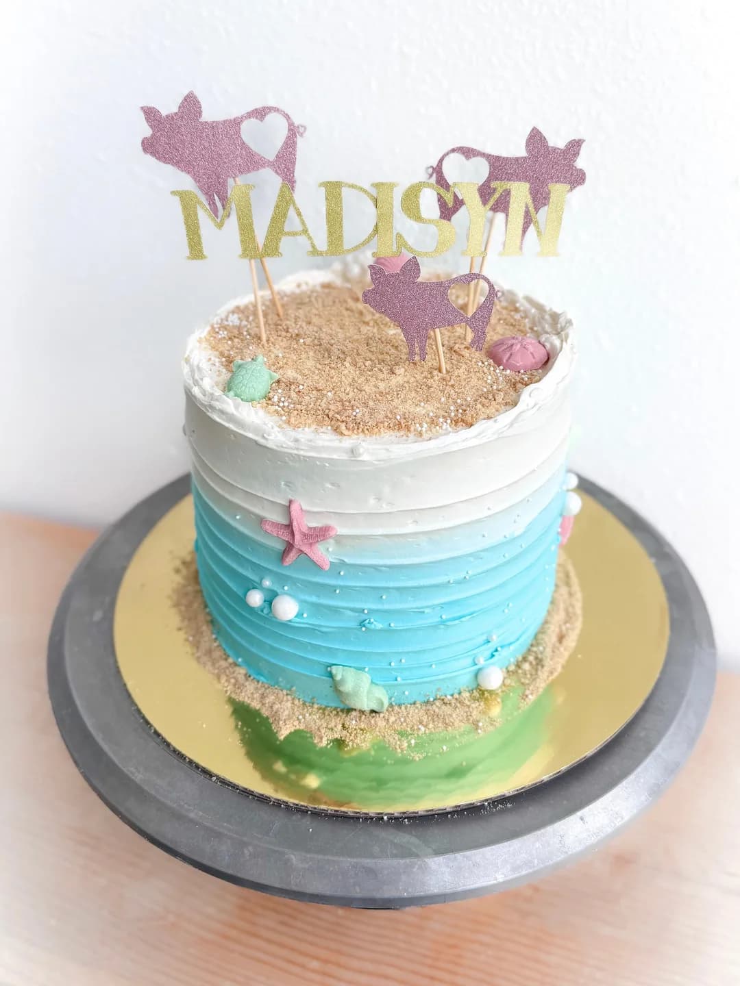 Beach-themed birthday cake with waves and sand