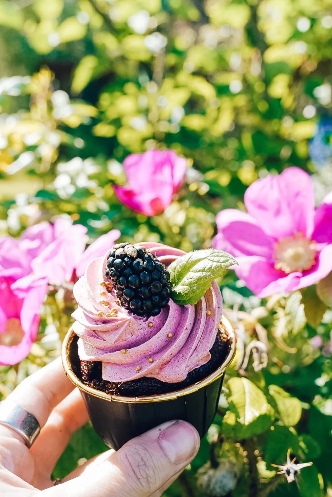 Blackberry cupcake among wild roses