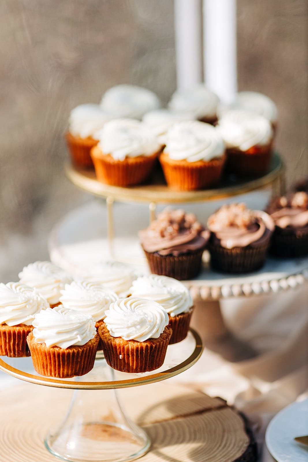 Vanilla and chocolate cupcakes on a gold tiered stand