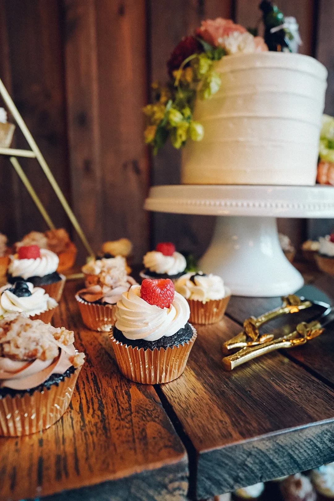 Dessert table with cupcakes and a white cake