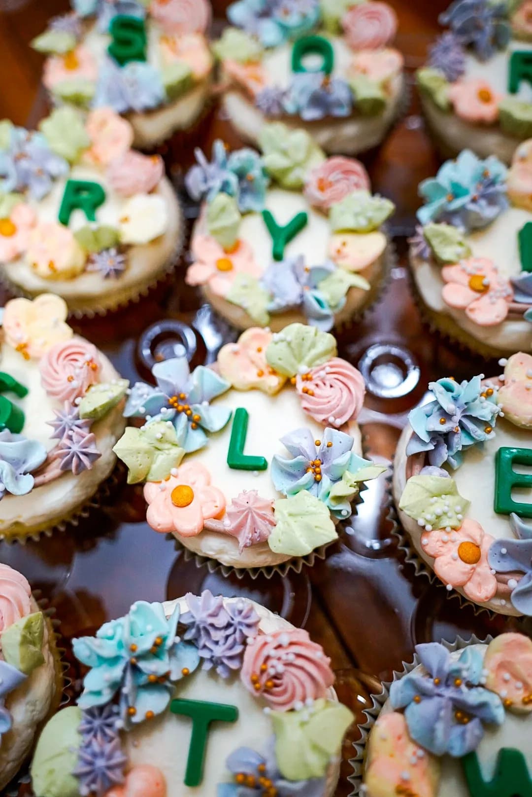 Buttercream flower cupcakes spelling a name