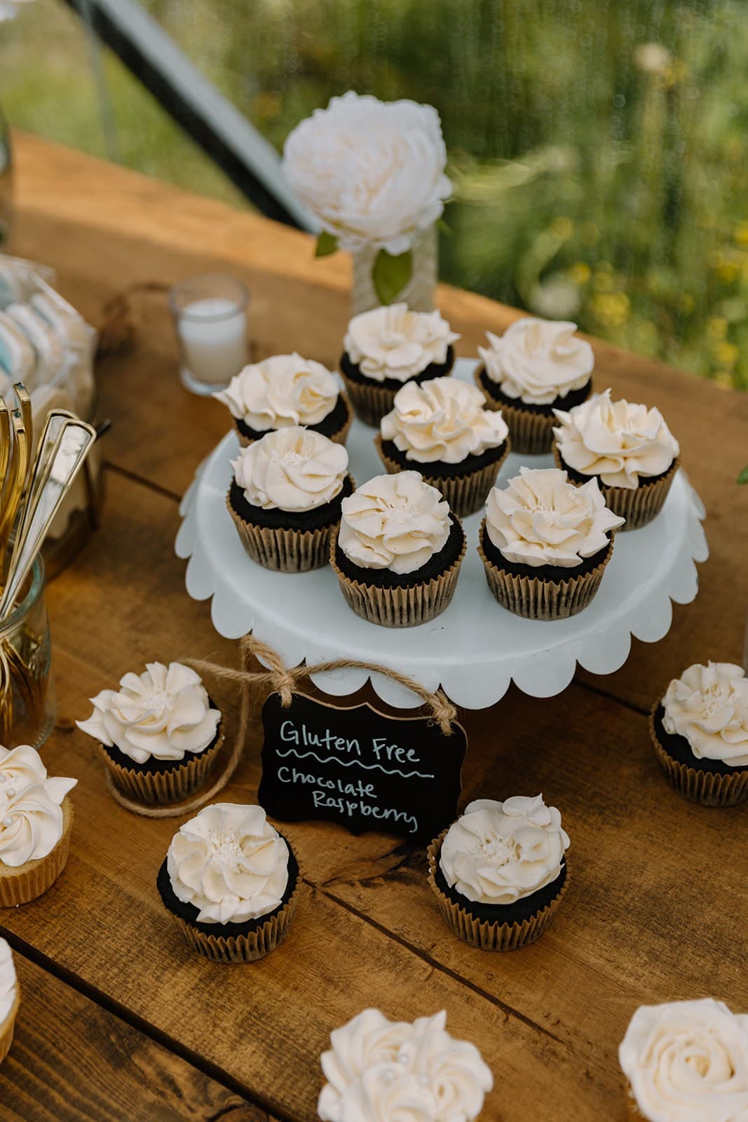 Gluten-free chocolate raspberry cupcakes on a white stand