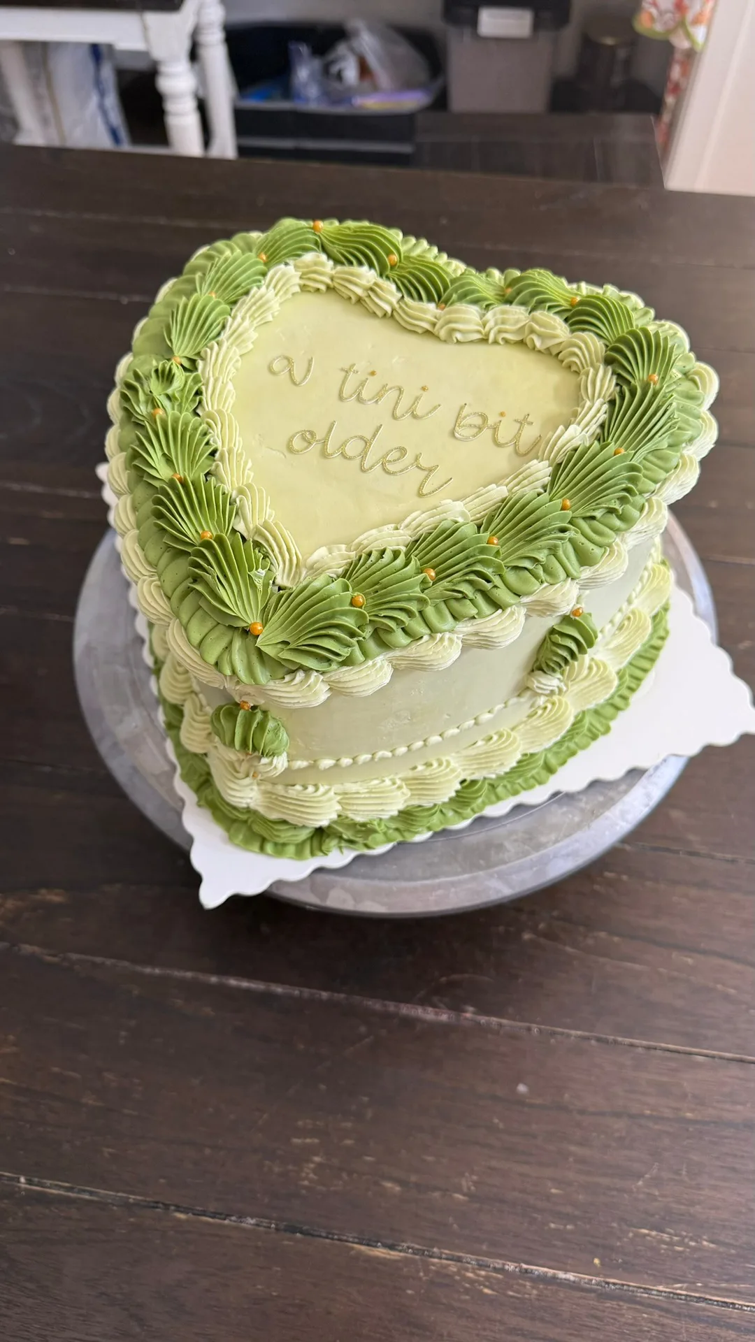 Green vintage-piped heart cake with hand lettering