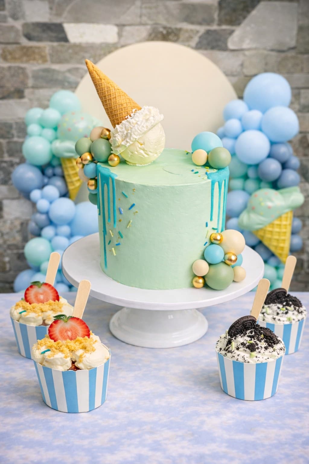 Mint drip cake with ice cream cone topper and balloon garland