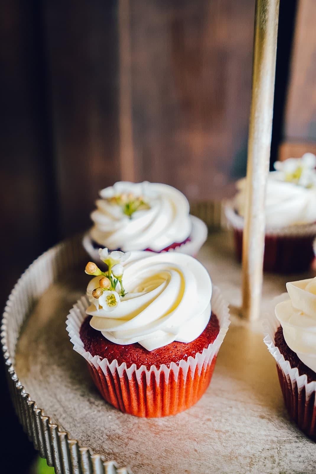 Red velvet cupcake with white swirl on a tiered stand