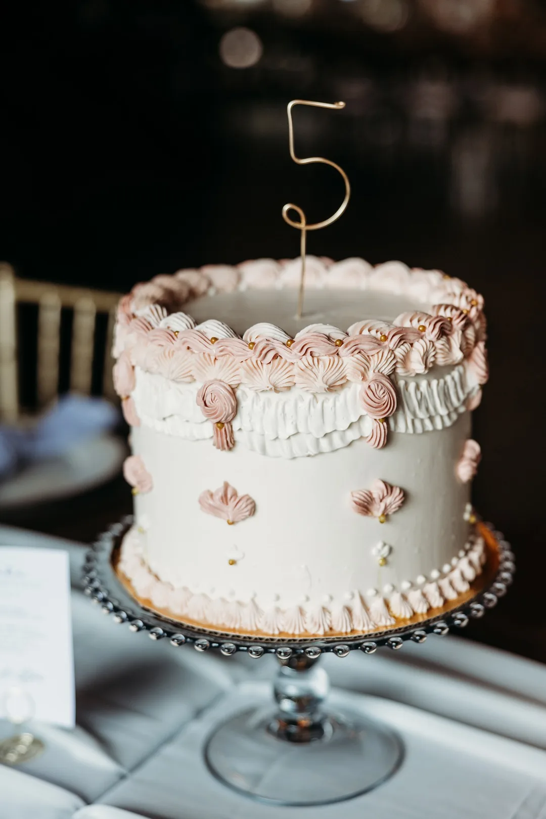Vintage-piped white and pink buttercream cake